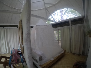 The bedroom and much needed mosquito net at the Manulalu Jungle Resort