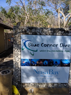 a signpost welcoming people to Blue Corner Dive